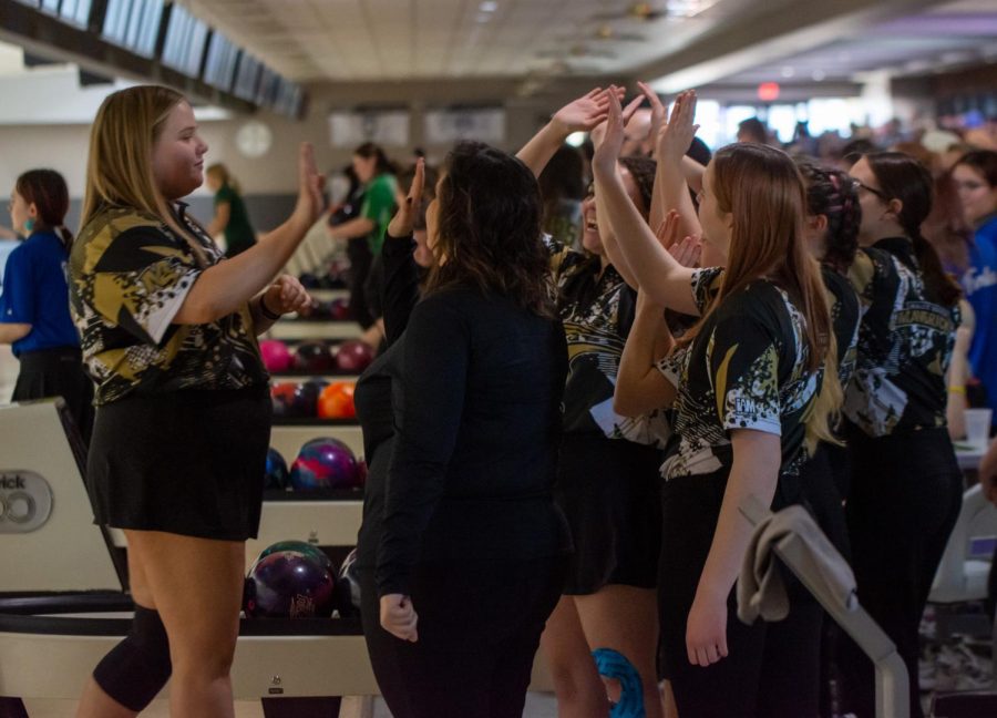 Kinley Barker celebrates with her teammates and coach. Barker bowled a 474 series on Friday. Maize Souths girls team placed sixth in the tournament.