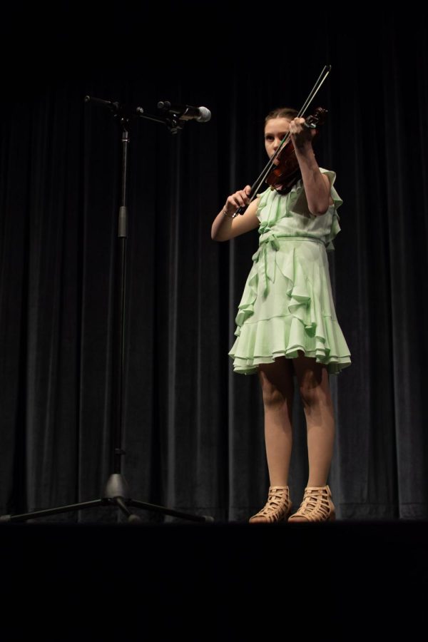 Maize South Intermediate student Kylie Powell plays her violin on stage. She performed the song “Minuet No. 1” by Johann Bach.