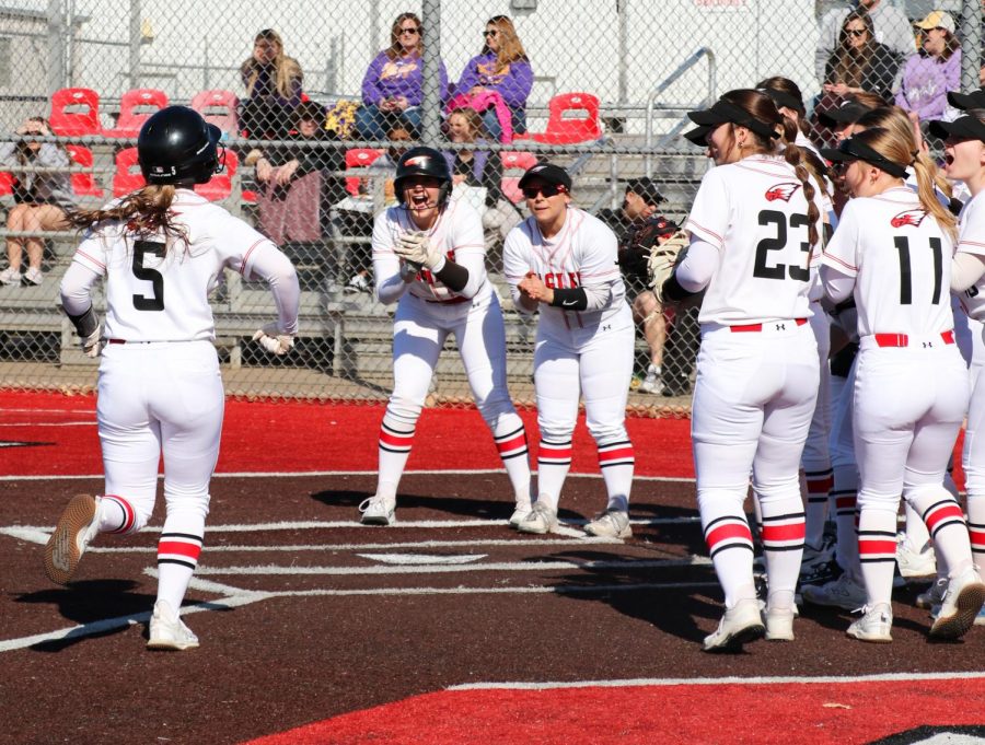 The entire team waits on home plate to celebrate senior Kennedy Topping after she hits the first home run of the game. Topping leads the team this season with a batting average of 0.600. 

