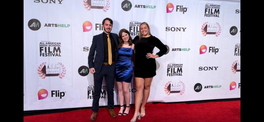 OneMaize Media videographers Sydney Lampkin and Stahley Sears pose with Seamless Productions editor-in-chief Andrew Percival at the All-American High School Film Festival red carpet event in November 2022. Percival was a finalist in two different categories and OneMaize Media scored five finalists in the prestigious nationwide film, cinema and broadcast competition.