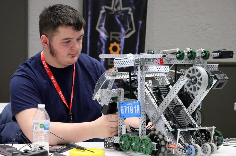 At the state VEX Robotics Competition, Sophomore Gage Wiley works on fixing his teams robot after a game before entering another one. “ Our team name is Agoraphobic,” Elizabeth Akers said. “Overall, the name captures the pressure felt behind doing well in these competitions.” The team made it to the quarter-finals, then got disqualified due to a malfunction of their string end game expansion.