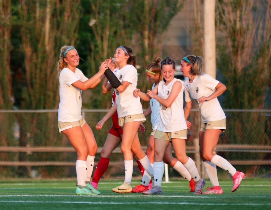 Maize South freshman Caroline Giroux and Avery Fellows celebrate with their teammates moments after Fellows scores a goal for the Mavericks. The Mavericks defeat the Eagles 3-0. 