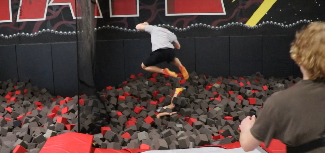 Students jumping into a foam pit