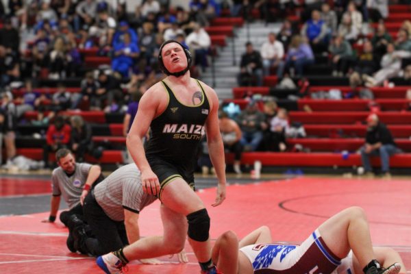 Wrestler James Conway pins his opponent and wins.