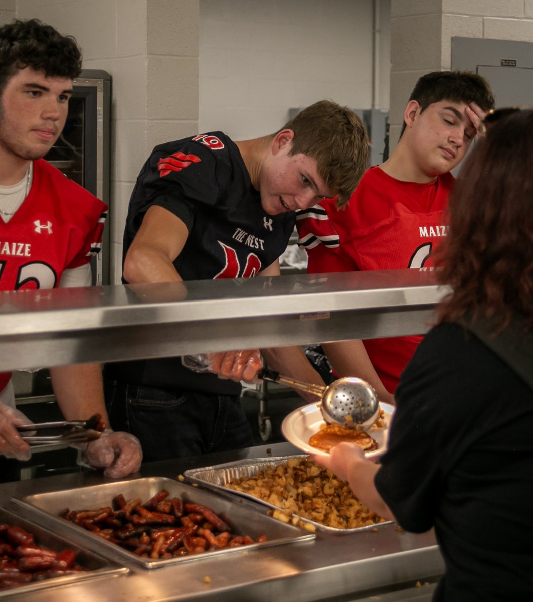 Senior Jackson Salsbury dishes out food to some hungry parents.