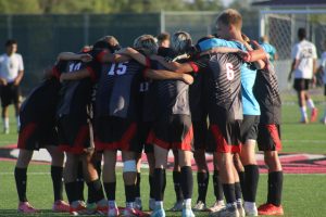 The Eagles huddle before kickoff, discussing their game plan.