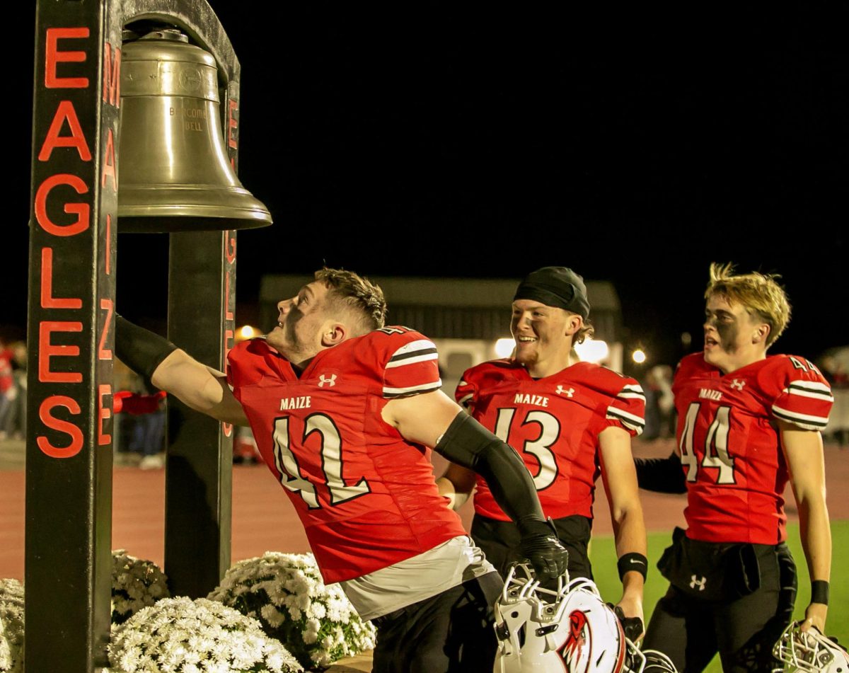 Maize High School football players ring bell