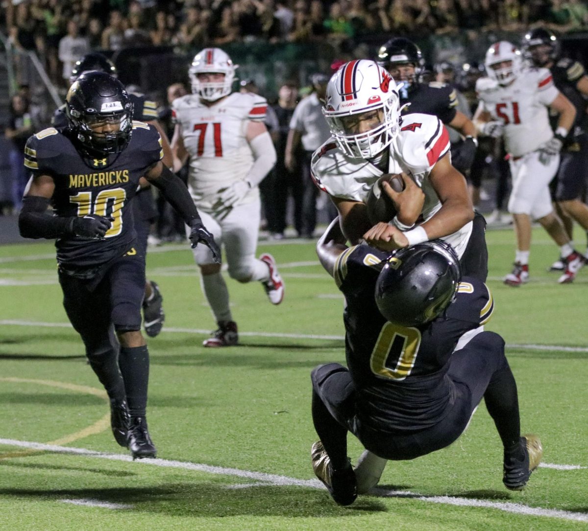 Junior Brayden Myovela runs toward the end zone before being brought down by Senior Leonel Sweet