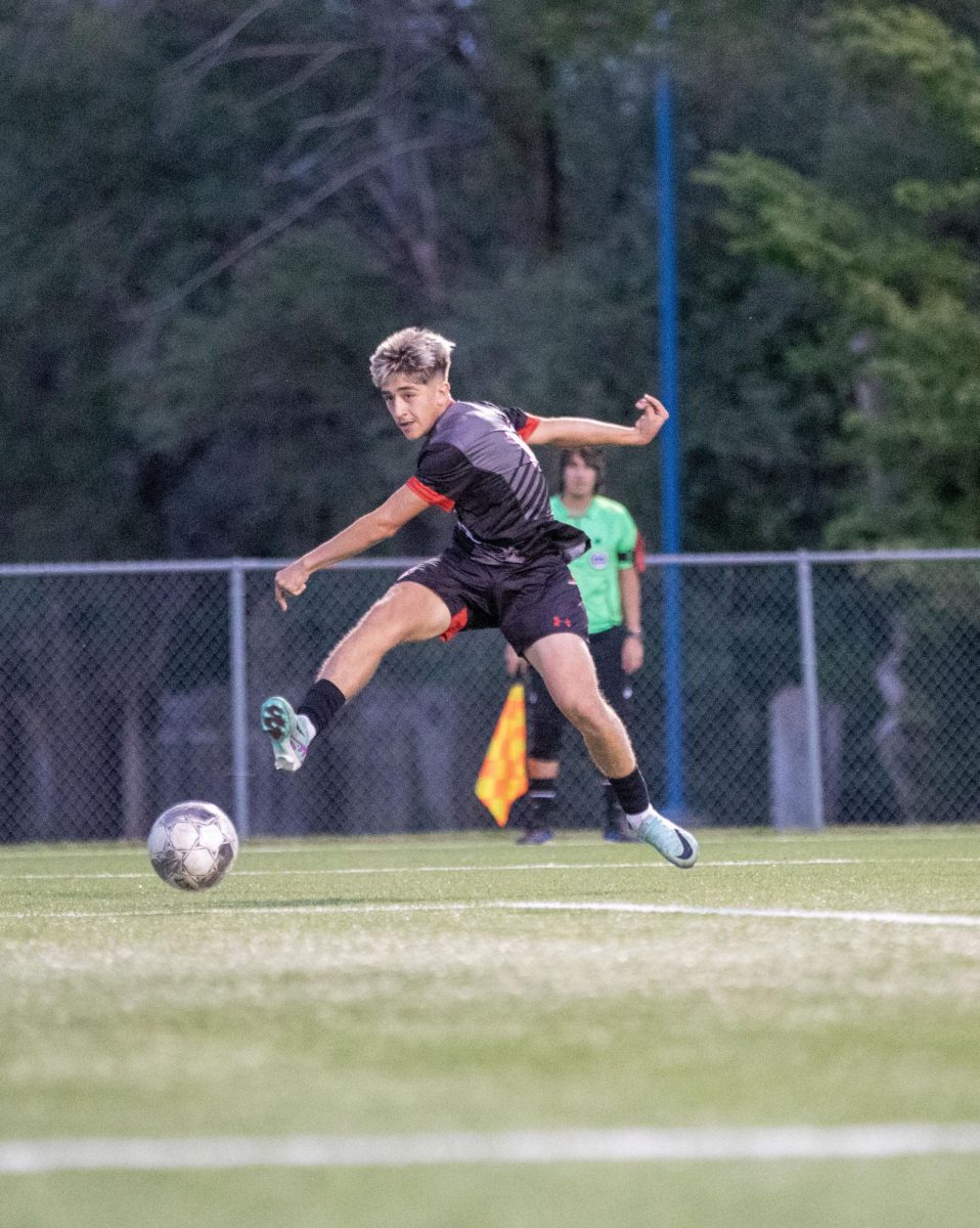 Sophomore Max Fernandez kicks the ball towards the goal as he reaches the end of the field. 