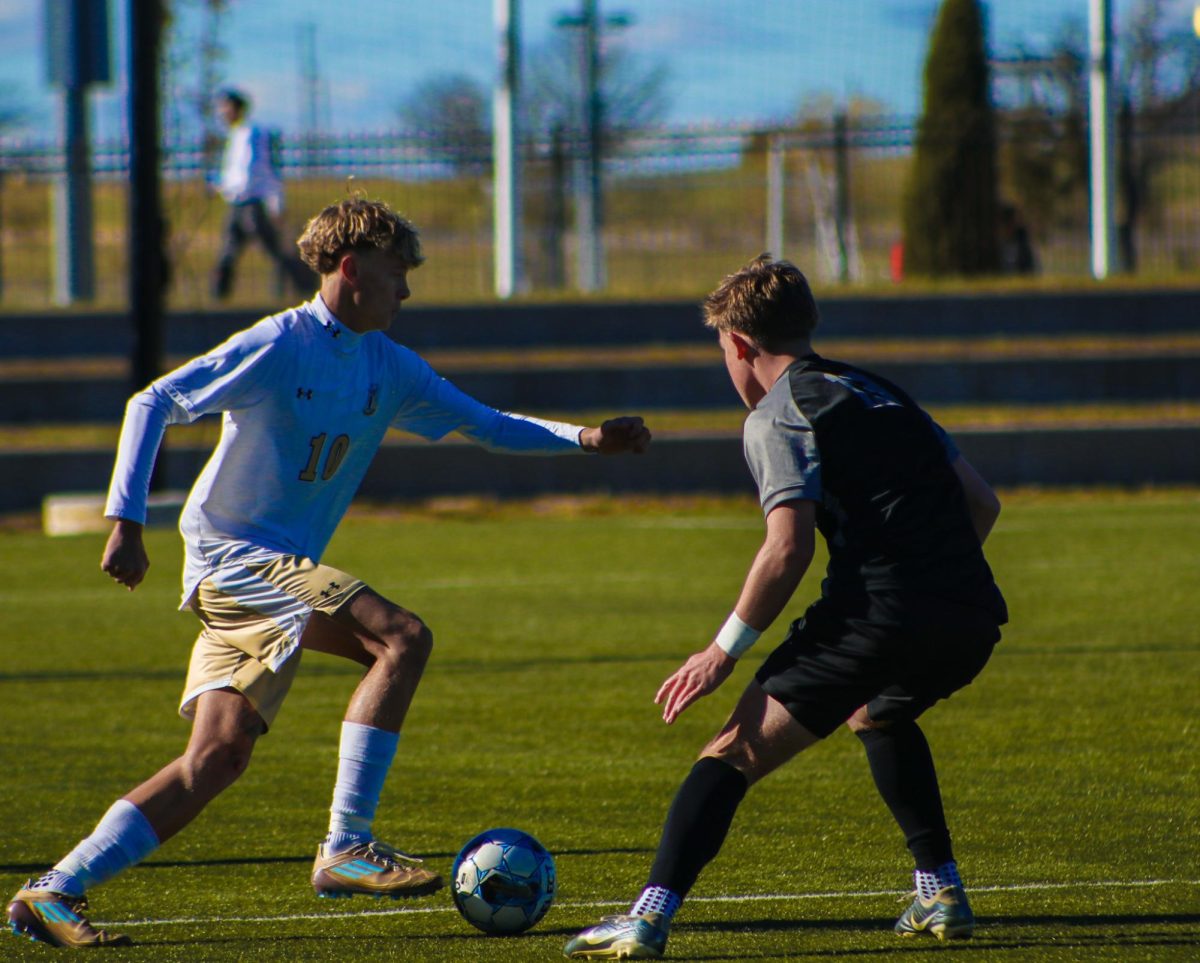 Junior Skylur Staley works his way around a Blue Valley Soutwest in the state final game.