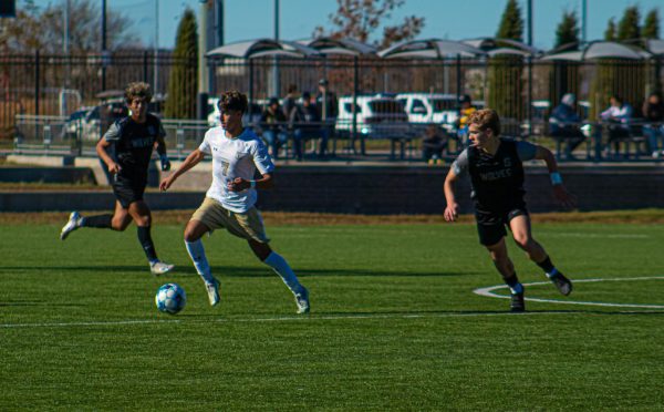 Danny Derath, senior center midfielder, dribbles, into the offensive third on a breakaway during the state final game against Blue Valley Southwest.